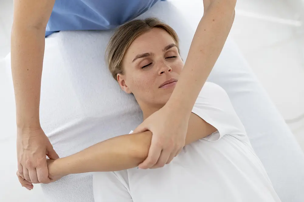 Woman wearing white t-shirt getting an Assisted Stretching Massage laying on table