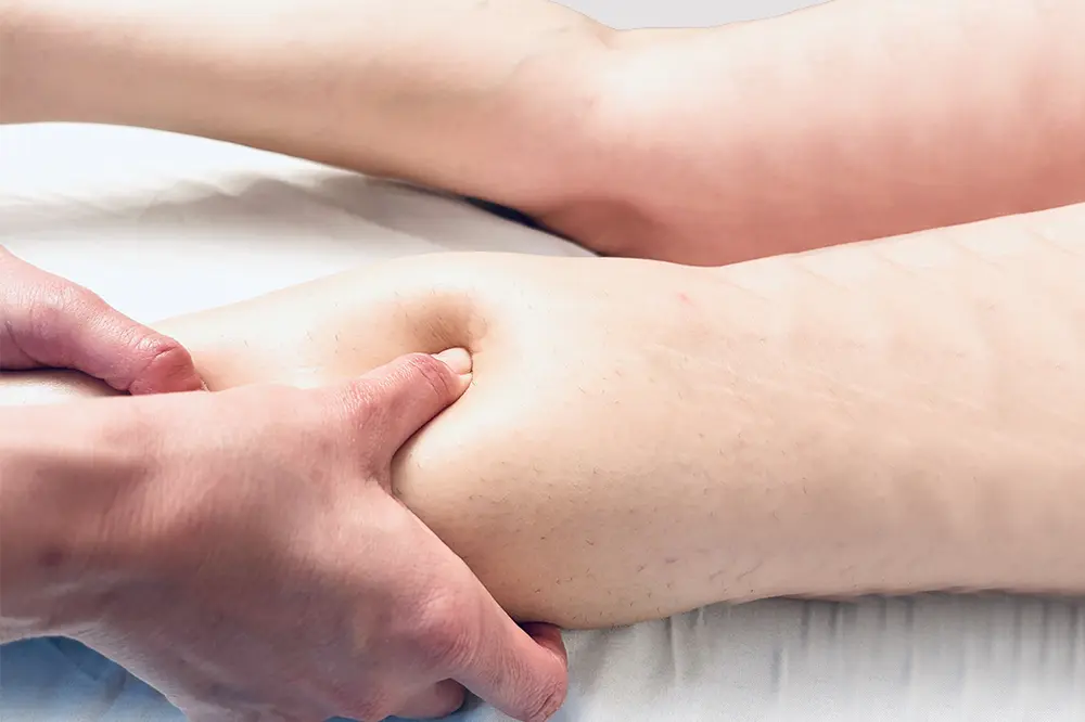 Woman Getting a Circulatory Massage on her legs