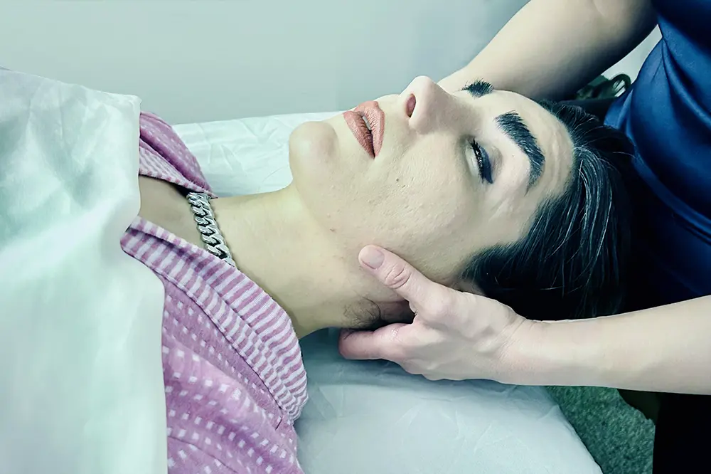 Woman laying on table getting a craniosacral massage